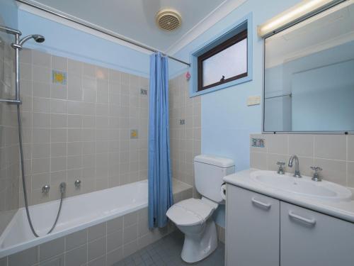 a bathroom with a toilet and a sink and a shower at Carindale Unit 21 19 Dowling Street in Nelson Bay