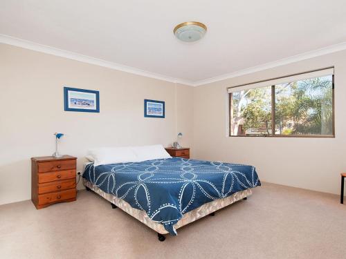 a bedroom with a bed and a window at Misthaven Unit 1 12 Mistral Close in Nelson Bay