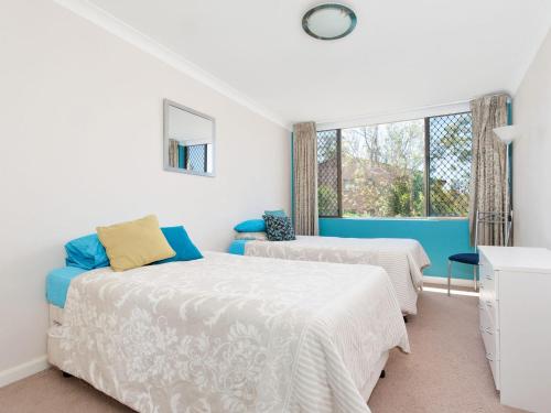 a bedroom with two beds and a window at Mistral Court Unit 16 17 Mistral Close in Nelson Bay