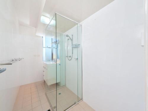 a glass shower in a bathroom with a sink at Ocean Shores Unit 10 27 Weatherly Close in Nelson Bay