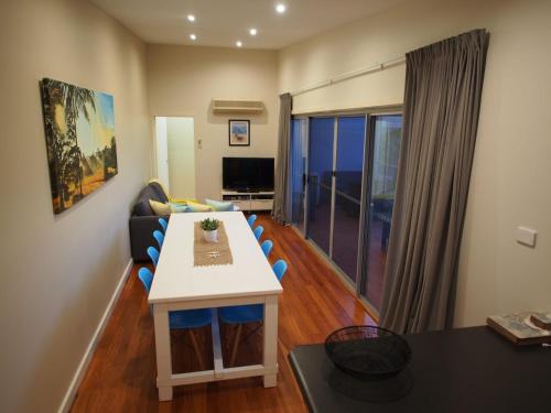 a living room with a table and a couch at Pollys View 117A Government Road in Nelson Bay