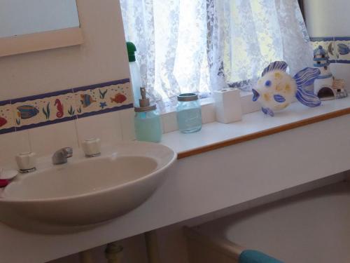 a bathroom counter with a sink and a window at Portside Unit 12 1 Donald Street in Nelson Bay