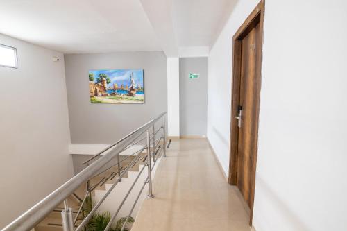 a staircase in a house with a painting on the wall at Hotel Amoek in Cartagena de Indias