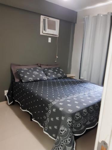 a bedroom with a bed with two pillows on it at Porto Real Resort Suites Angra in Mangaratiba