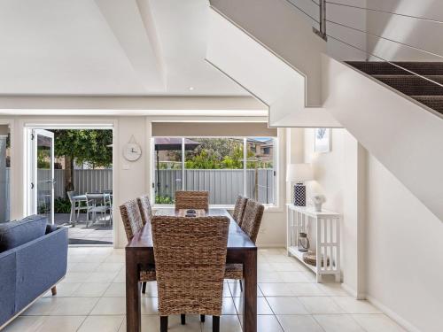 a dining room with a table and chairs at Sandcastles 7 8 Ala Moana Way in Fingal Bay