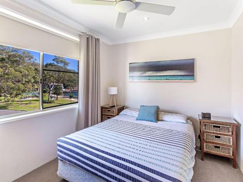 a bedroom with a bed and a window at Collendina Unit 6 19 Kurrawa Close in Nelson Bay