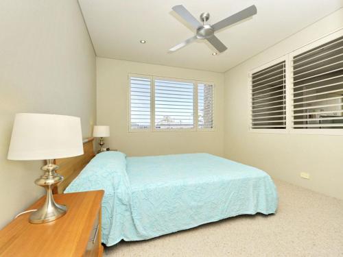 a bedroom with a bed and a ceiling fan at Del Rae Unit 12 25 Shoal Bay Road in Shoal Bay