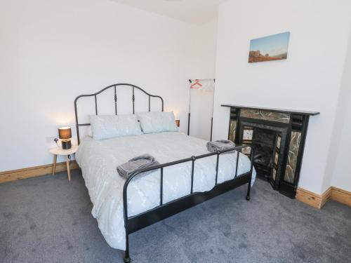 a bedroom with a bed and a fire place at Hilderthorpe House in Bridlington