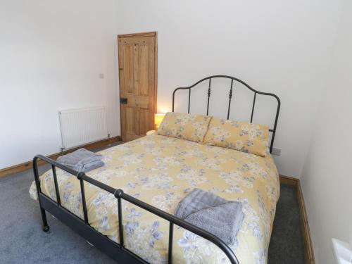 a bedroom with a bed with a metal frame at Hilderthorpe House in Bridlington