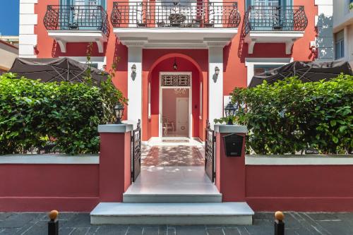 a red and white building with a door at Via Villa Iliotti Rhodos in Rhodes Town