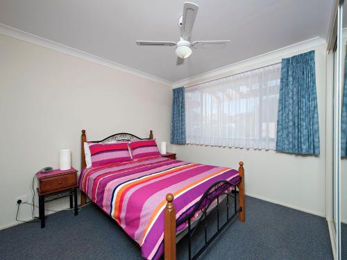 a bedroom with a bed and a window at The Breakers 16B Government Road in Shoal Bay