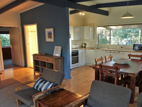 A kitchen or kitchenette at Wonky Pine Beach House, NARRWALLEE- 4 bedroom