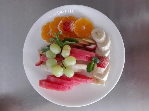 a plate of fruit and vegetables on a plate at Best Hostel in Kathmandu