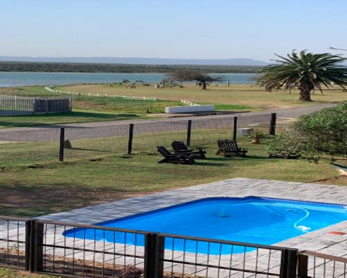 a view of a swimming pool with a fence at 28 Kabeljauws in Jeffreys Bay