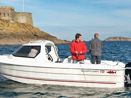 two men standing on a boat in the water at Five-Bedroom Holiday home in Jelsa 2 in Jelsa