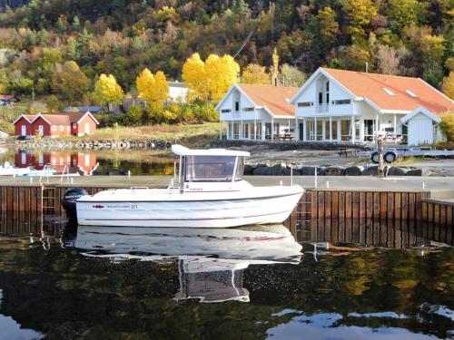 a boat is docked in the water next to houses at Five-Bedroom Holiday home in Jelsa 2 in Jelsa