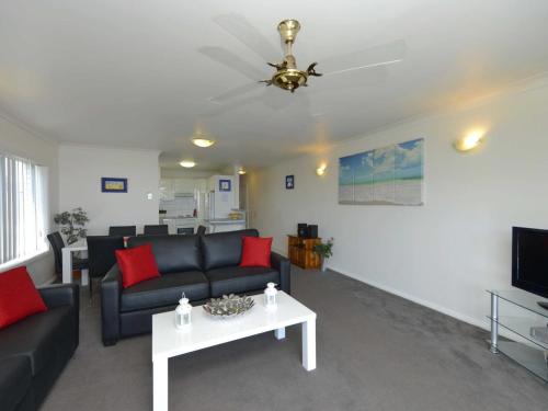 a living room with a couch and a table at Sundeck Unit 9 51 Ronald Avenue in Shoal Bay