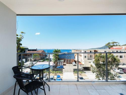 a view from the balcony of a apartment with a table and chairs at The Shoal, Unit 309/4-8 Bullecourt Street in Shoal Bay
