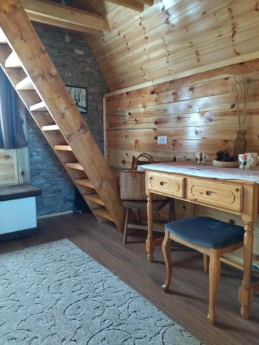 a wooden room with a desk and a staircase at Planinska kuca-Jovanovic! in Kremna