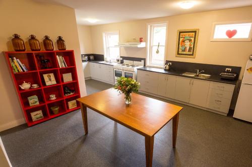 a kitchen with a wooden table in a room at Montacute Boutique Bunkhouse in Hobart