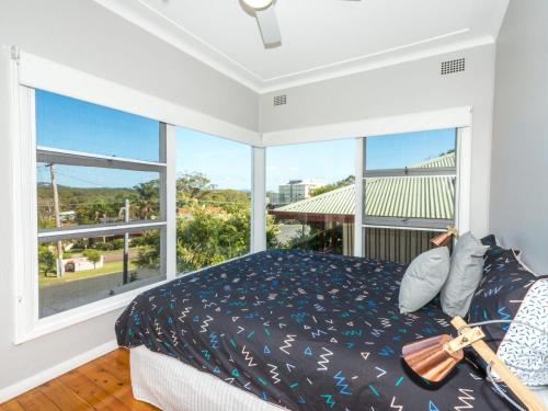 a bedroom with a bed and a large window at Victor Parade 5 in Shoal Bay