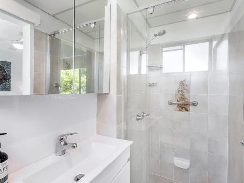 a white bathroom with a sink and a shower at Victory Court Unit 1 3 7 Columbia Close in Nelson Bay