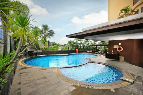 a swimming pool in the middle of a building at youre at - Grand Setiabudhi Apartment in Bandung