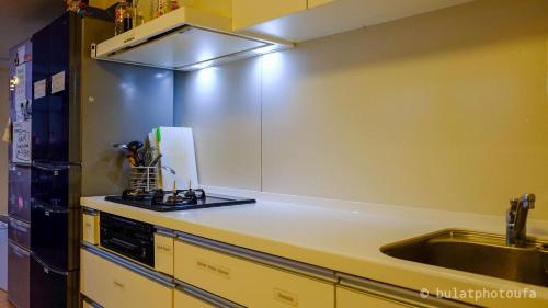 a kitchen with a sink and a counter top at City view guesthouse Private room - Vacation STAY 85052 in Osaka