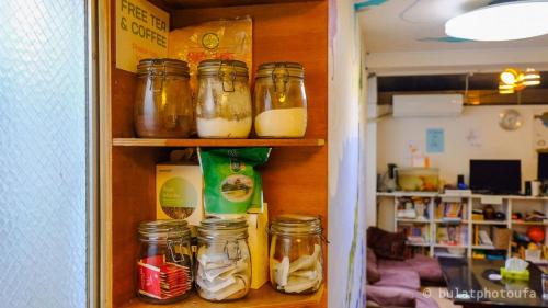 a pantry with jars of food and other ingredients at City view guesthouse Private room - Vacation STAY 85052 in Osaka