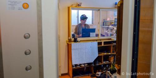 a woman standing at a counter in a room at City view guesthouse Private room - Vacation STAY 85052 in Osaka
