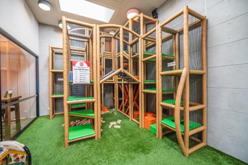 a play room with wooden stairs and green chairs at The Peakhurst in Peakhurst