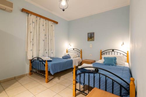 Ένα ή περισσότερα κρεβάτια σε δωμάτιο στο Lenna's Villas Zante