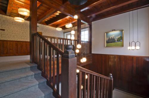 a wooden staircase in a house with lights at Aparthotel Panorama in Deštné v Orlických horách