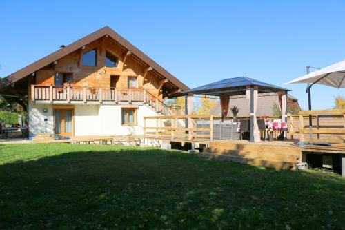 a house with a large yard in front of it at Chalet Savoyard Balcon de Villy in Étaux