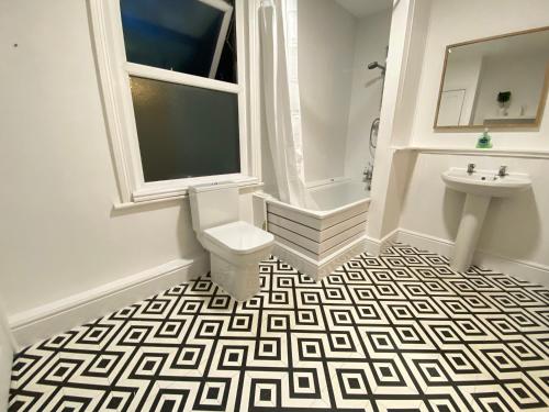 a bathroom with a toilet and a sink at 4 Bed house sleeps 8 next to Chatham station and Chatham city centre in Chatham