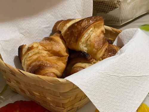 a basket filled with croissants on top of a table at Villa Lilia by Let in Siena