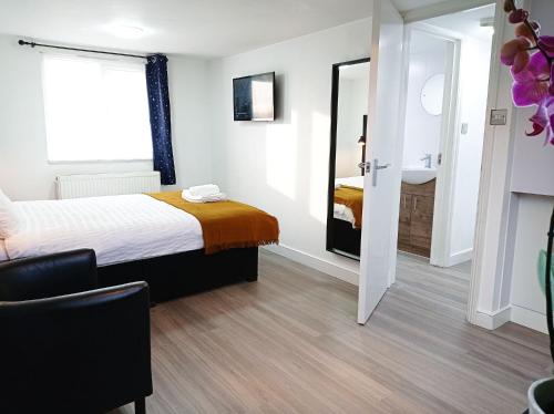 a hotel room with a bed and a mirror at Mill Studio A - Self contained one bed studio flat in Oxford