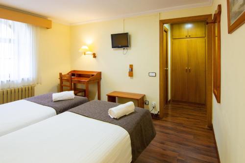 Letto o letti in una camera di Hotel Vall de Núria