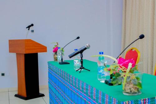 a table with two microphones and a podium at Hôtel Ivotel Abidjan in Abidjan