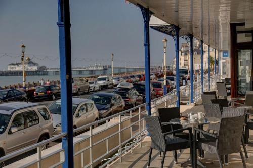 a restaurant with cars parked in a parking lot at Best Western York House Hotel in Eastbourne