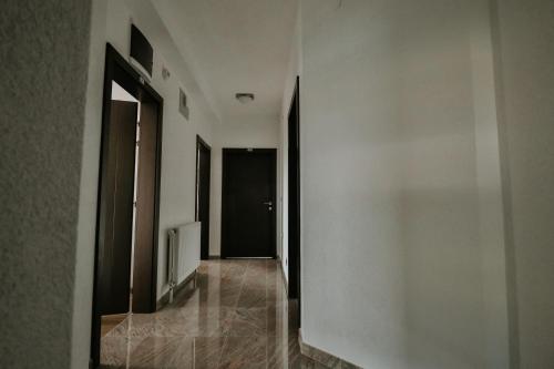 a hallway with white walls and a black door at Villa TEMA in Ohrid