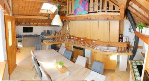 a kitchen and dining room with a table and chairs at Chalet Savoyard Balcon de Villy in Étaux