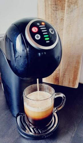 a coffee maker is making a cup of coffee at 't Nieuwe Nest in Kaatsheuvel