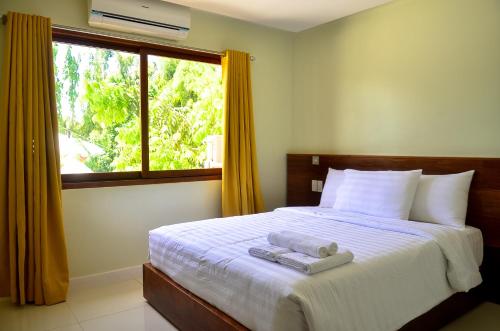 A bed or beds in a room at Marianne Hotel