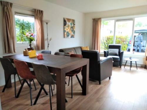 a living room with a wooden table and chairs at Holiday rentals in Velsen-Zuid
