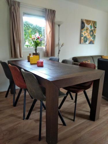 a dining room table with chairs and a couch at Holiday rentals in Velsen-Zuid