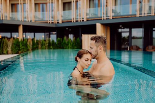 a man and a woman in a swimming pool at Ratscher Landhaus in Ratsch an der Weinstraße