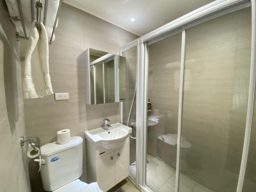 a bathroom with a toilet and a sink and a shower at Hotel Huru House in Taichung