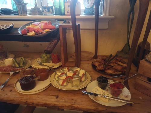RanumにあるNæsbydale Badehotelの食べ物の皿が置かれた木製のテーブル