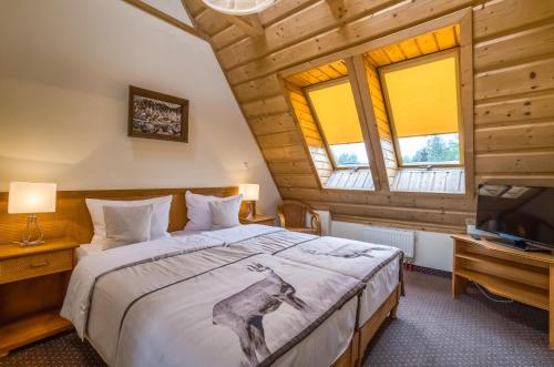 מיטה או מיטות בחדר ב-Hotel Nosalowy Dwór